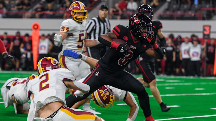 South Dakota running back Charles Pierre Jr. (3) charges through the Northern State defense on Thursday, Aug. 29, 2024, at the Dakota Dome in Vermillion, S.D.