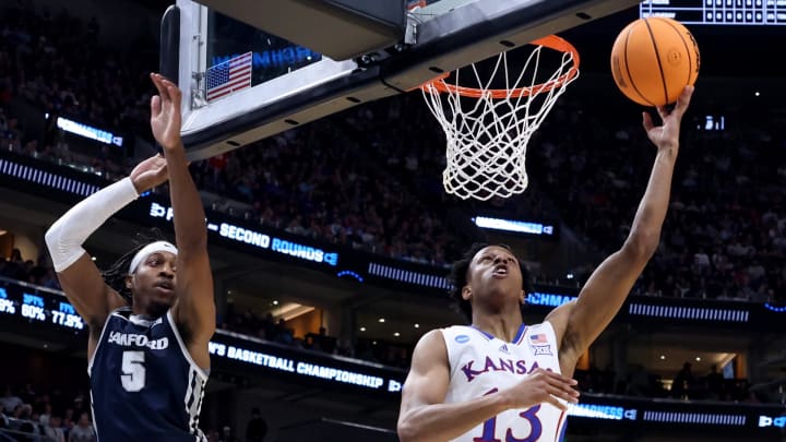 Mar 21, 2024; Salt Lake City, UT, USA; Kansas Jayhawks guard Elmarko Jackson (13) drives against Samford Bulldogs guard A.J. Staton-McCray (5)