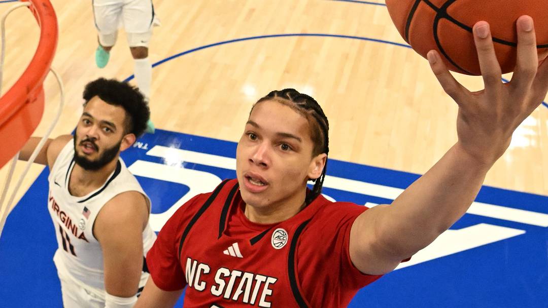 Mar 12, 2026; Charlotte, NC, USA; NC State Wolfpack guard Matt Able (3) scores as Virginia Cavaliers forward Devin Tillis (11) defends in the first half at Spectrum Center. Mandatory Credit: Bob Donnan-Imagn Images