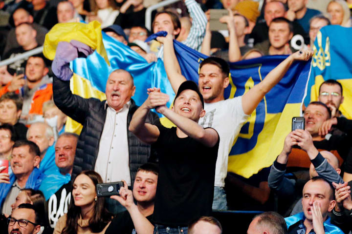 Fans cheer for Oleksandr Usyk before his match against Chazz Witherspoonbox during a heavyweight boxing match 