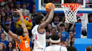 Feb 22, 2025; Lawrence, Kansas, USA; Kansas Jayhawks forward KJ Adams Jr. (24) dunks the ball as Oklahoma State Cowboys guard Brandon Newman (6) defends during the first half at Allen Fieldhouse. Mandatory Credit: Denny Medley-Imagn Images