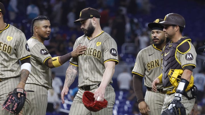 Aug 9, 2024; Miami, Florida, USA;  San Diego Padres designated hitter Luis Arraez (4) and relief pitcher Tanner Scott (66) celebrate their win against the Miami Marlins at loanDepot Park. Mandatory Credit: Rhona Wise-USA TODAY Sports