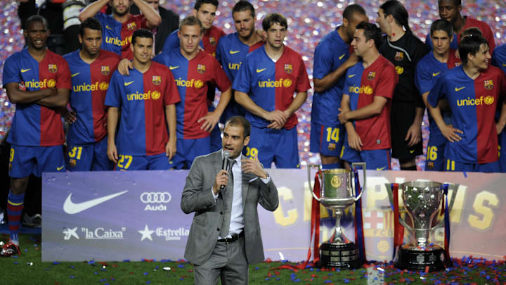 Barcelona's coach Pep Guardiola (C, down