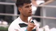 Carlos Alcaraz speaks to the chair umpire during a French Open match.