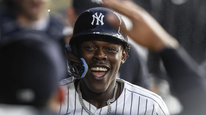 Aug 8, 2024; Bronx, New York, USA;  New York Yankees third baseman Jazz Chisholm Jr. (13) is greeted in the dugout after hitting a solo home run in the second inning against the Los Angeles Angels at Yankee Stadium.