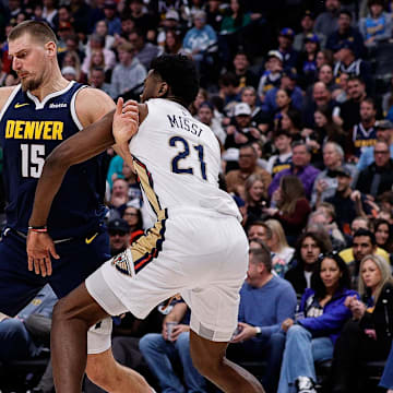 Oct 29, 2025; Denver, Colorado, USA; Denver Nuggets center Nikola Jokic (15) controls the ball as New Orleans Pelicans center Yves Missi (21) defends in the third quarter at Ball Arena. Mandatory Credit: Isaiah J. Downing-Imagn Images