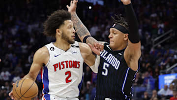 Oct 19, 2022; Detroit, Michigan, USA;  Detroit Pistons guard Cade Cunningham (2) is defended by Orlando Magic forward Paolo Banchero (5) in the second half at Little Caesars Arena. Mandatory Credit: Rick Osentoski-Imagn Images