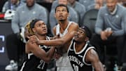 Oct 26, 2025; San Antonio, Texas, USA; Brooklyn Nets forward Noah Clowney (21) and center Day'Ron Sharpe (20) push San Antonio Spurs forward Victor Wembanyama (1) back in the second half at Frost Bank Center. Mandatory Credit: Daniel Dunn-Imagn Images