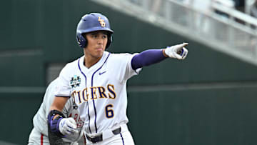 Jun 18, 2025; Omaha, Neb, USA;  LSU Tigers left fielder Derek Curiel (6) points to the dugout after hitting a double against the Arkansas Razorbacks during the first inning at Charles Schwab Field. Mandatory Credit: Steven Branscombe-Imagn Images