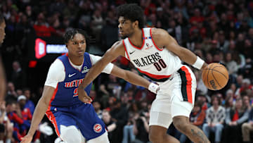 Mar 9, 2025; Portland, Oregon, USA; Portland Trail Blazers guard Scoot Henderson (00) dribbles the ball past Detroit Pistons forward Ausar Thompson (9) in the first half at Moda Center. Mandatory Credit: Jaime Valdez-Imagn Images