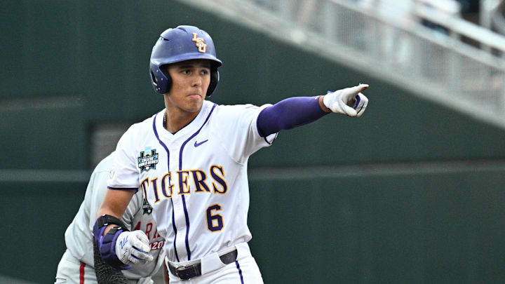 Jun 18, 2025; Omaha, Neb, USA;  LSU Tigers left fielder Derek Curiel (6) points to the dugout after hitting a double against the Arkansas Razorbacks during the first inning at Charles Schwab Field. Mandatory Credit: Steven Branscombe-Imagn Images