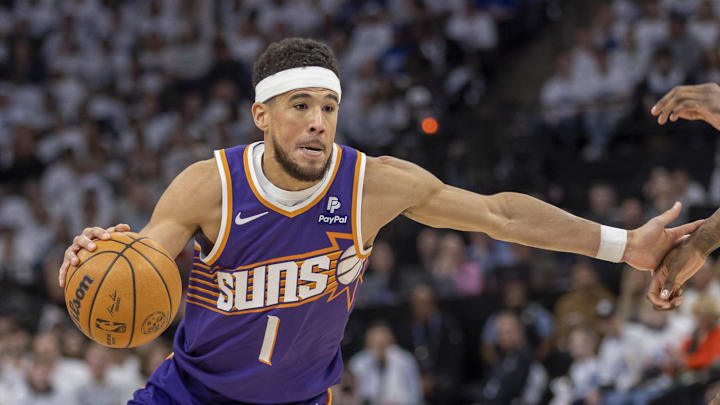 Apr 20, 2024; Minneapolis, Minnesota, USA; Phoenix Suns guard Devin Booker (1) dribbles the ball against the Minnesota Timberwolves in the first half during game one of the first round for the 2024 NBA playoffs at Target Center. Mandatory Credit: Jesse Johnson-Imagn Images