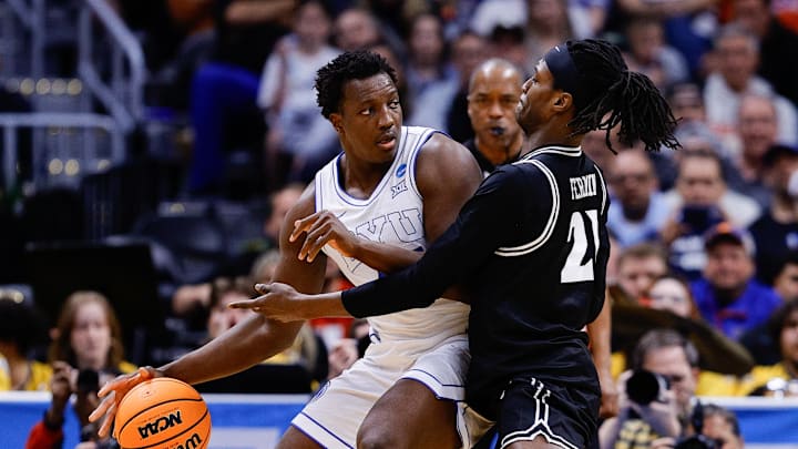 Mar 20, 2025; Denver, CO, USA; VCU Rams forward Christian Fermin (21) defends against Brigham Young Cougars center Fousseyni Traore (45) during the first half in the first round of the NCAA Tournament at Ball Arena. Mandatory Credit: Isaiah J. Downing-Imagn Images