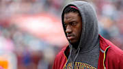 Oct 4, 2015; Landover, MD, USA; Washington Redskins quarterback Robert Griffin III stands the bench against the Philadelphia Eagles at FedEx Field. Mandatory Credit: Geoff Burke-Imagn Images