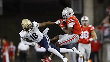 Sep 25, 2021; Columbus, Ohio, USA; Ohio State Buckeyes wide receiver Garrett Wilson (5)makes the catch over Akron Zips cornerback A.J. Watts (18)during the second quarter at Ohio Stadium. Mandatory Credit: Joseph Maiorana-USA TODAY Sports