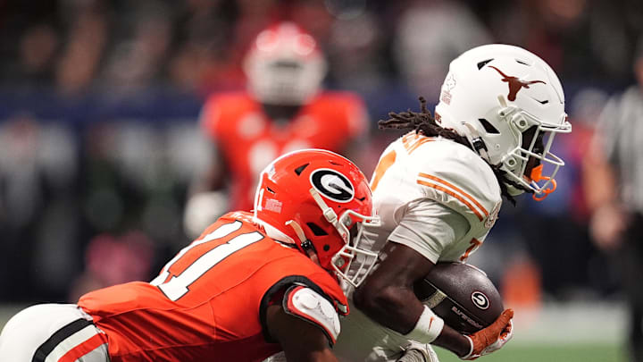 Dec 7, 2024; Atlanta, GA, USA; Texas Longhorns wide receiver Silas Bolden (11) makes a catch agaistn Georgia Bulldogs linebacker Jalon Walker (11) during the first half in the 2024 SEC Championship game at Mercedes-Benz Stadium. Mandatory Credit: Dale Zanine-Imagn Images