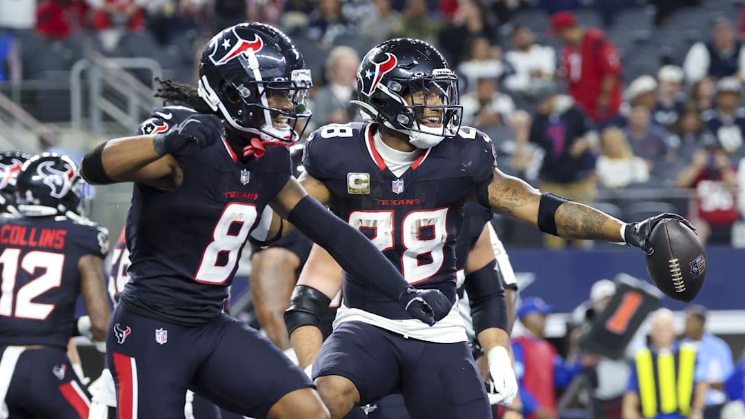 Nov 18, 2024; Arlington, Texas, USA; Houston Texans running back Joe Mixon (28) celebrates with Houston Texans wide receiver John Metchie III (8) after scoring a touchdown during the second half against the Dallas Cowboys at AT&T Stadium. Mandatory Credit: Kevin Jairaj-Imagn Images