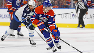 Oct 9, 2024; Edmonton, Alberta, CAN; Edmonton Oilers forward Ryan Nugent-Hopkins (93) looks top make a pass in front of Winnipeg Jets forward Alex Iafallo (9) during the first period at Rogers Place. Mandatory Credit: Perry Nelson-Imagn Images