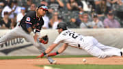 Jul 12, 2025; Chicago, Illinois, USA; Chicago White Sox left fielder Andrew Benintendi (23) steals third base as Cleveland Guardians third baseman Jose Ramirez (11) fields a relay throw during the fourth inning at Rate Field. Mandatory Credit: Patrick Gorski-Imagn Images