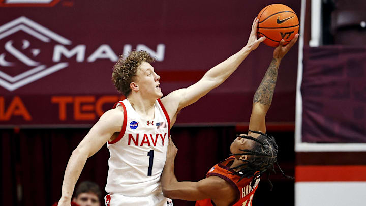 Dec 15, 2024; Blacksburg, Virginia, USA; Navy Midshipmen guard Austin Benigni (1) blocks the shot of Virginia Tech Hokies guard Ben Hammond (11) during the second half at Cassell Coliseum. Mandatory Credit: Peter Casey-Imagn Images Dec 15, 2024; Blacksburg, Virginia, USA; Navy Midshipmen guard Austin Benigni (1) blocks the shot of Virginia Tech Hokies guard Ben Hammond (11) during the second half at Cassell Coliseum. Mandatory Credit: Peter Casey-Imagn Images