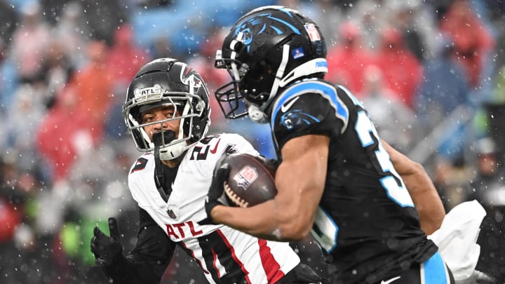 Dec 17, 2023; Charlotte, North Carolina, USA;  Carolina Panthers running back Chuba Hubbard (30) runs as Atlanta Falcons cornerback A.J. Terrell (24) defends in the first quarter at Bank of America Stadium. 