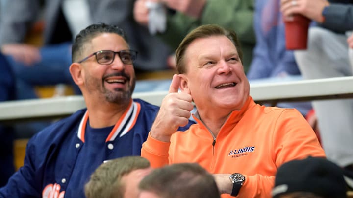 Illini head coach Brad Underwood, in orange, and associate head coach Orlando Antigua greet fans at the Class 3A Washington Sectional semifinal Tuesday, March 4, 2025.