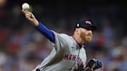 Sep 11, 2025; Philadelphia, Pennsylvania, USA; New York Mets pitcher Reed Garrett (75) shows a pitch against the Philadelphia Phillies during the sixth inning at Citizens Bank Park. Mandatory Credit: Bill Streicher-Imagn Images
