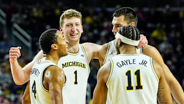 From left, Michigan guard Nimari Burnett (4), center Danny Wolf (1), center Vladislav Goldin (50) and guard Roddy Gayle Jr. (11) celebrate a play against Oregon during the second half at Crisler Center in Ann Arbor on Wednesday, Feb. 5, 2025.