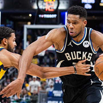 Nov 3, 2025; Indianapolis, Indiana, USA; Milwaukee Bucks forward Giannis Antetokounmpo (34) dribbles the ball while  Indiana Pacers forward Jeremiah Robinson-Earl (25) defends in the second half at Gainbridge Fieldhouse. Mandatory Credit: Trevor Ruszkowski-Imagn Images
