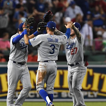 Jul 13, 2019; Boston, MA, USA; Los Angeles Dodgers center fielder A.J. Pollock (11), left fielder Chris Taylor (3) and right fielder Alex Verdugo (27) celebrate after defeating the Boston Red Sox at Fenway Park. Mandatory Credit: Bob DeChiara-Imagn Images