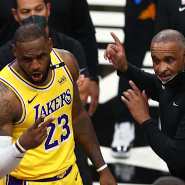 Los Angeles Lakers forward LeBron James (23) and assistant coach Phil Handy against the Phoenix Suns. 