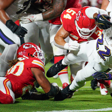 Sep 5, 2024; Kansas City, Missouri, USA; Baltimore Ravens running back Derrick Henry (22) scores a touchdown as Kansas City Chiefs linebacker Leo Chenal (54) attempts the tackle during the first half at GEHA Field at Arrowhead Stadium. Mandatory Credit: Denny Medley-Imagn Images