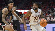 Feb 3, 2024; Louisville, Kentucky, USA; Florida State Seminoles guard Darin Green Jr. (22) dribbles against Louisville Cardinals guard Tre White (22) during the first half at KFC Yum! Center. Mandatory Credit: Jamie Rhodes-USA TODAY Sports