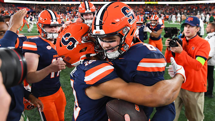 Nov 30, 2024; Syracuse, New York, USA; Syracuse Orange quarterback Kyle McCord (right) celebrates with tight end Jamie Tremble (left) following a game against the Miami Hurricanes at the JMA Wireless Dome. Mandatory Credit: Rich Barnes-Imagn Images