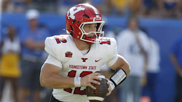 Sep 21, 2024; Pittsburgh, Pennsylvania, USA;  Youngstown State Penguins quarterback Beau Brungard (12) scrambles with the ball against the Pittsburgh Panthers during the first quarter at Acrisure Stadium. Mandatory Credit: Charles LeClaire-Imagn Images