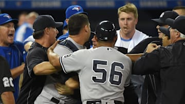 Sep 26, 2016; Toronto, Ontario, CAN;  Toronto Blue Jays first baseman Justin Smoak (14) looks on as New York Yankees staff and players restrain catcher Gary Sanchez (24) during a bench clearing brawl in the third inning at Rogers Centre. Mandatory Credit: Dan Hamilton-Imagn Images