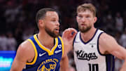 Apr 16, 2024; Sacramento, California, USA; Golden State Warriors guard Stephen Curry (30) dribbles the ball in front of Sacramento Kings forward Domantas Sabonis (10) in the fourth quarter during a play-in game of the 2024 NBA playoffs at the Golden 1 Center.