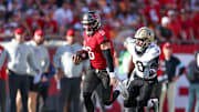 Jan 5, 2025; Tampa, Florida, USA; Tampa Bay Buccaneers quarterback Baker Mayfield (6) runs with the ball against the New Orleans Saints in the fourth quarter  at Raymond James Stadium. Mandatory Credit: Nathan Ray Seebeck-Imagn Images