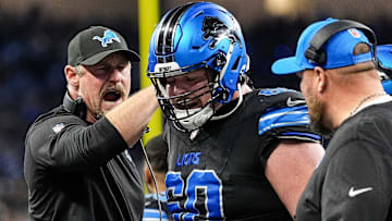 Detroit Lions head coach Dan Campbell talks to guard Graham Glasgow (60) after a play against Buffalo Bills during the first half at Ford Field in Detroit on Sunday, Dec. 15, 2024.