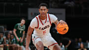 Nov 3, 2025; Coral Gables, Florida, USA; Miami Hurricanes forward Malik Reneau (5) dribbles the basketball against the Jacksonville Dolphins during the second half at Watsco Center. Mandatory Credit: Sam Navarro-Imagn Images