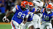 Florida Gators defensive tackle Michai Boireau (93) celebrates with safety Bryce Thornton (18) after an interception during the second half at Ben Hill Griffin Stadium.