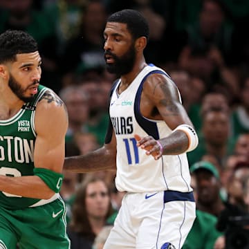 Jun 17, 2024; Boston, Massachusetts, USA; Boston Celtics forward Jayson Tatum (0) controls the ball against Dallas Mavericks guard Kyrie Irving (11) during the second quarter in game five of the 2024 NBA Finals at TD Garden. Mandatory Credit: Peter Casey-Imagn Images