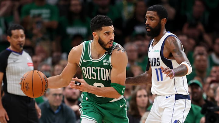 Jun 17, 2024; Boston, Massachusetts, USA; Boston Celtics forward Jayson Tatum (0) controls the ball against Dallas Mavericks guard Kyrie Irving (11) during the second quarter in game five of the 2024 NBA Finals at TD Garden. Mandatory Credit: Peter Casey-Imagn Images