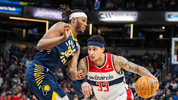 Jan 10, 2024; Indianapolis, Indiana, USA; Washington Wizards forward Kyle Kuzma (33) dribbles the ball while Indiana Pacers center Myles Turner (33) defends in the first half at Gainbridge Fieldhouse. Mandatory Credit: Trevor Ruszkowski-Imagn Images