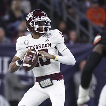 Dec 27, 2023; Houston, TX, USA; Texas A&M Aggies quarterback Marcel Reed (10) looks for an open receiver during the first quarter against the Oklahoma State Cowboys at NRG Stadium. Mandatory Credit: Troy Taormina-Imagn Images