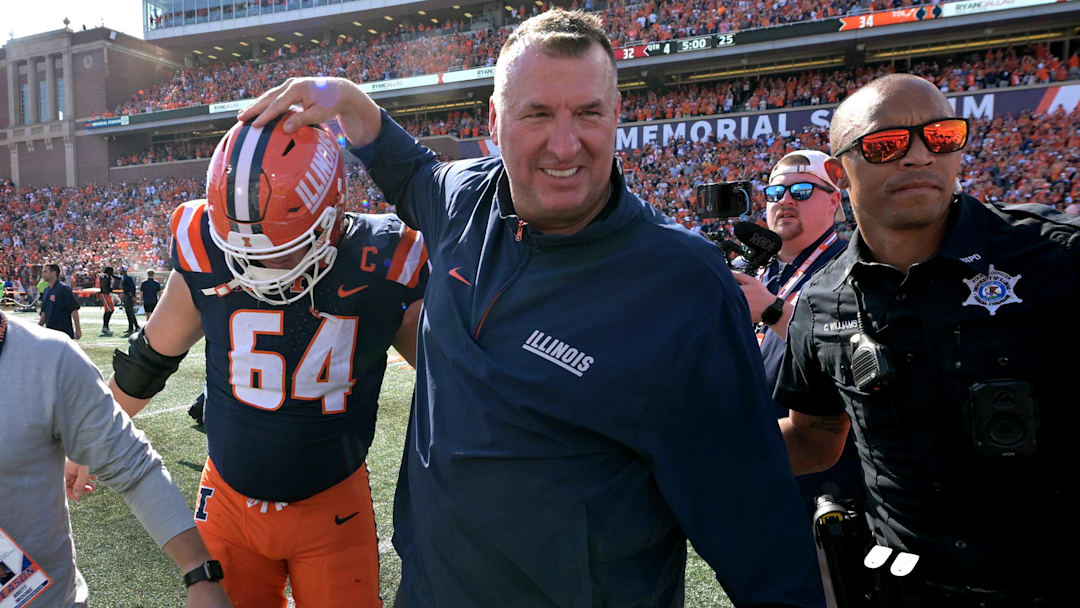 Sep 27, 2025; Champaign, Illinois, USA;  Illinois Fighting Illini head coach Bret Bielema gives players a hand after a 34-32 win against the Southern California Trojans at Memorial Stadium. Mandatory Credit: Ron Johnson-Imagn Images
