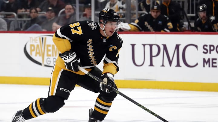 Mar 14, 2024; Pittsburgh, Pennsylvania, USA; Pittsburgh Penguins center Sidney Crosby (87) moves the puck up ice against the San Jose Sharks during the first period at PPG Paints Arena. Mandatory Credit: Charles LeClaire-USA TODAY Sports