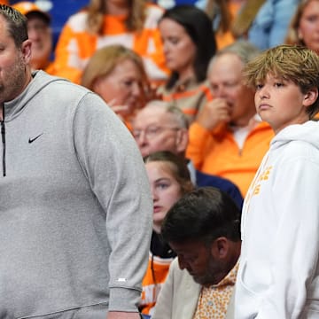 A Tennessee fan takes a photos with Tennessee football coach Josh Heupel at the NCAA Tournament Elite Eight game between Tennessee and Houston at Lucas Oil Stadium in Indianapolis, Ind., on Sunday, March 30, 2025.