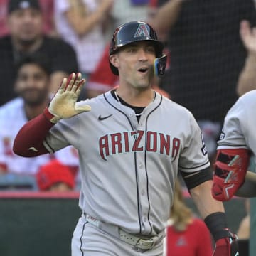 Jul 12, 2025; Anaheim, California, USA;  Arizona Diamondbacks third baseman Eugenio Suarez (28) is greeted by right fielder Randal Grichuk (15) at the dugout after hitting a solo home run during the second inning against the Los Angeles Angels at Angel Stadium. Mandatory Credit: Jayne Kamin-Oncea-Imagn Images