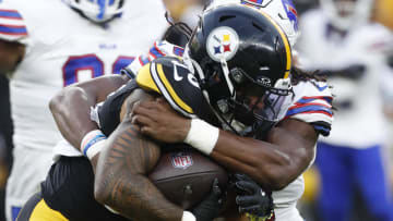 Aug 17, 2024; Pittsburgh, Pennsylvania, USA;  Pittsburgh Steelers running back Jalen Warren (30) carries the ball against Buffalo Bills linebacker Dorian Williams (42) during the second quarter at Acrisure Stadium. Mandatory Credit: Charles LeClaire-USA TODAY Sports